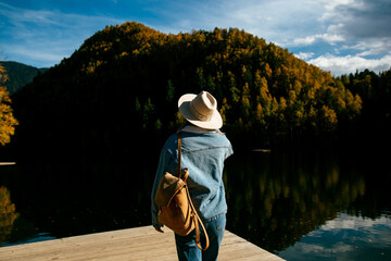 A girl in a hat at the autumn forest