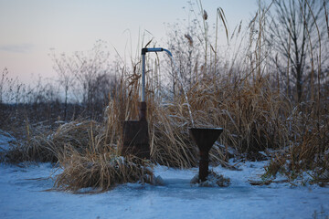 snow covered water pump in winter