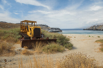 Abandoned bulldozer on the beach