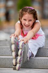 cute little girl on roller skates at park.