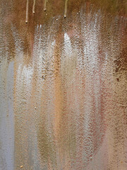 texture of an old metal rusty garage wall painted with different paints and silver