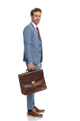 happy young man in blue suit standing in line and waiting