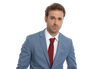 portrait of attractive young businessman in blue suit posing