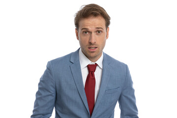 shocked young businessman in blue suit making a surprised face