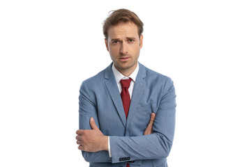 sexy elegant businessman in blue suit folding arms and being confident