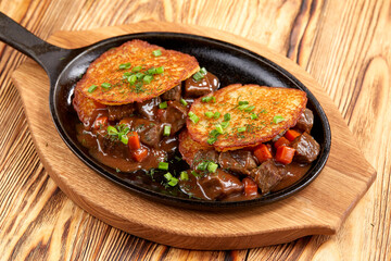 potato pancake with meaat on the pan