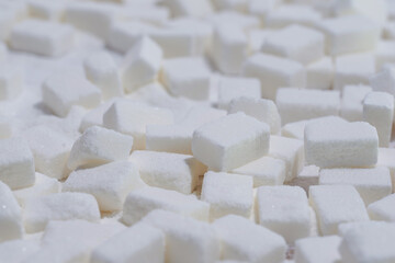 White sugar cubes on the pile. 