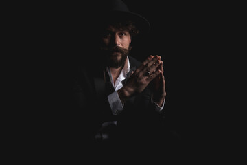 seated fashion model holding his hands together