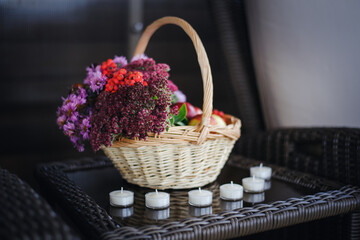 Fototapeta na wymiar Bouquet of autumn gifts in a basket with candels