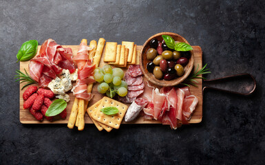 Antipasto with prosciutto, salami, crackers, cheese and olives