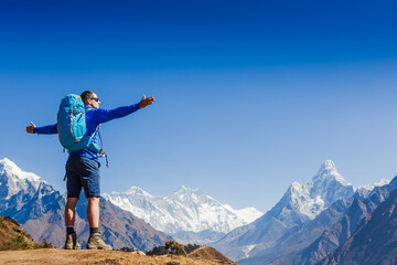 Hiker enjoying the view on the Everest trek in Himalayas, Ama Dablam mountain view, Nepal
