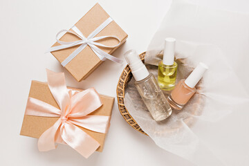 Fototapeta na wymiar Organic cosmetics and gifts for the holiday. Flat lay, top view clear glass pump bottle, brush jar, moisturizing serum jar in a paper basket on a white background. Natural cosmetics SPA