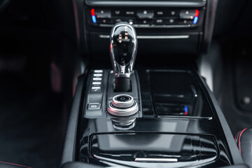 Modern luxury car interior. Control panel, radio system, shift lever. Automatic transmission...