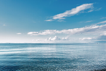 Minimalistic seascape with sea, sky and clouds