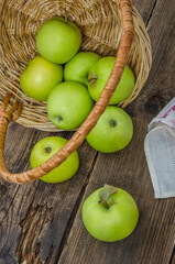 Ripe green apples in a wicker basket