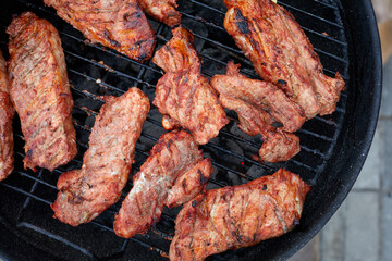 Grilled pork chop and vegetables on the flaming grill.