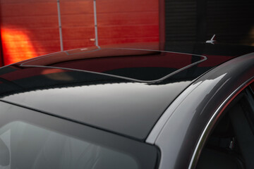 Part of roof of the car. Focus on the hatch of a new modern car. Closed car sunroof. Selective...