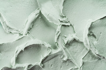 Green cosmetic clay mask texture close up.