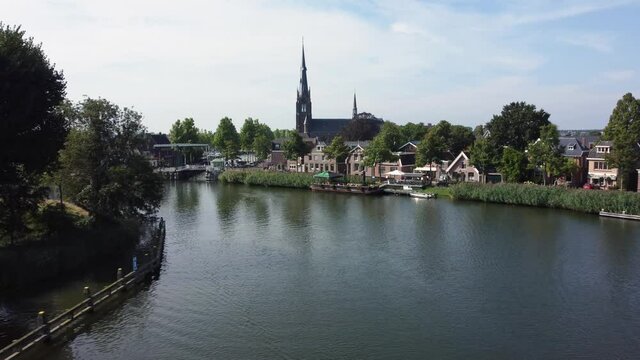 City Weesp in Holland flying over river Vecht towards church