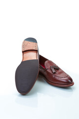 Pair of Traditional Formal Stylish Brown Pebble Grain Tassel Loafer Shoes On White