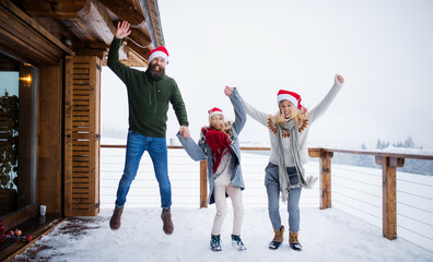 Family with small daughter having fun on terrace outdoors, holiday in Christmas time.