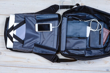 Flat Lays Concepts. Top View Flat Lay of Backpack With Laptop and Tablet, Mobile Phone And Charger...