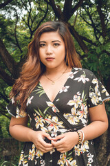 Portrait shot of a Classy young Filipino teen. Confident plus size woman in a fashionable floral...
