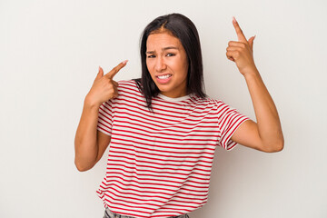 Young latin woman isolated on white background  showing a disappointment gesture with forefinger.