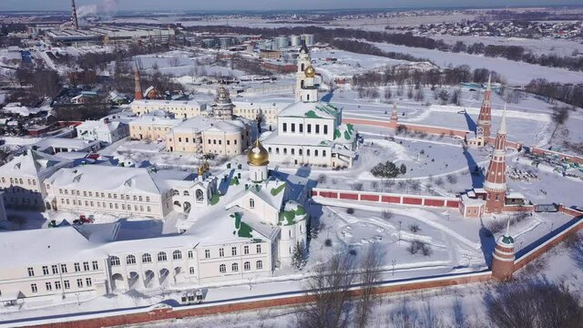 Aerial view in winter of the old Epiphany Staro-Golutvina monastery on the outskirts of the city of Kolomna and residential areas in the distance, Russia. 