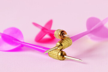 Pink darts over pink bacgkround -  Concept of woman power and teamwork