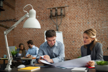 Happy down syndrome man with businesswoman colleague working in office, social inclusion and...