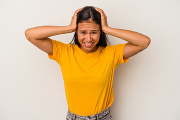 Young latin woman isolated on white background  screaming, very excited, passionate, satisfied with something.