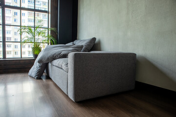 soft upholstered light sofa with modules in the interior with a panoramic window