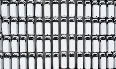 Full frame aerial view of new white vans parked together after manufacturing for import and export