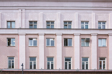 Vintage architecture classical fscade house. Simple pink building front view.