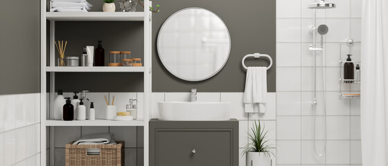 Close up of white bathroom sink on stylish cabinet with round mirror, shelves with bathing products