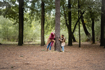 Obraz premium Smiling muslim girl playing with mother in park