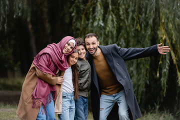Excited muslim family looking at camera outdoors