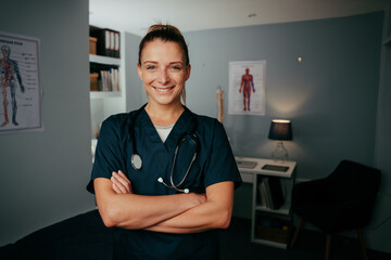 Caucasian female nurse standing with arms crossed in medical clinic