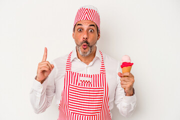 Middle age caucasian ice maker caucasian man holding an ice cream isolated on white background  having some great idea, concept of creativity.