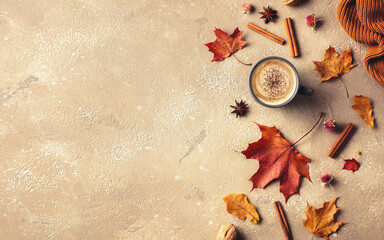 Beautiful autumn composition on beige background. Hot coffee, dried leaves, knitted blanket and spices