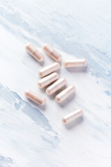 Fototapeta na wymiar Carnitine capsules. Concept for a healthy dietary supplementation. Bright wooden background. Soft focus. Close up. Copy space. 