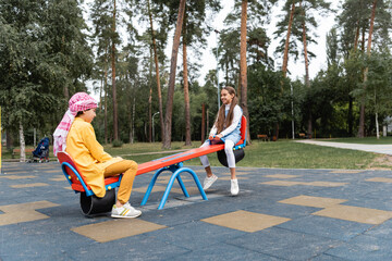 Arabian children playing on playground in park