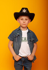 A small boy in the form of a cowboy depicts the emotions of arrogance