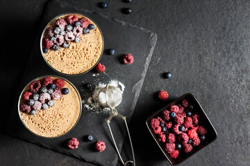 Ryazhenka mousse in glass bowls decorated with fresh berries