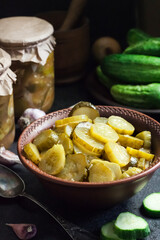 Pickled cucumber salad in a bowl and jars