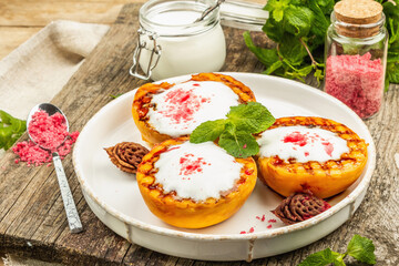 Grilled peach with yogurt, mint, and sweet pink sugar. Useful breakfast concept, healthy food