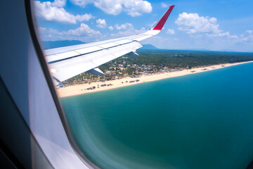 Tropical beach view from an airplane window. - 458006054