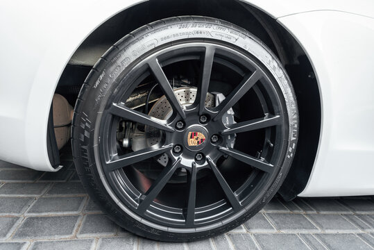 Ukraine, Odessa September 8 - 2021: A Cast Disc In Black Rim And A Brand Sign In The Center For A Porsche Boxter With Perforated Brakes. Porsche Alloy Wheel With Michelin Tires