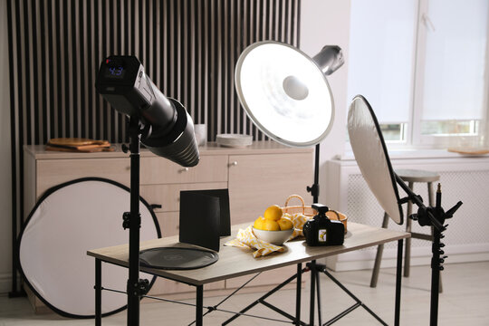 Professional camera and composition with ripe lemons on table in photo studio. Food photography